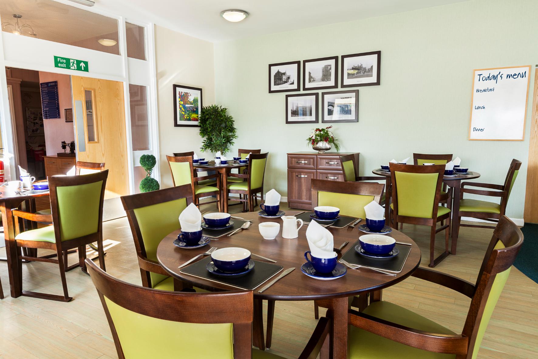 dining area with green wooden chairs